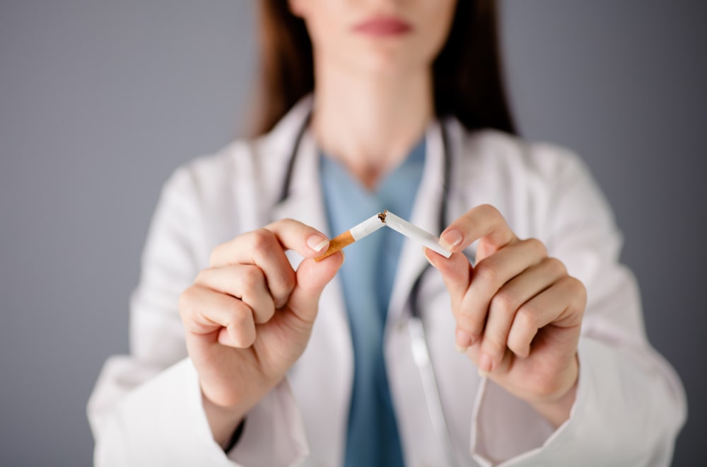 Smoking After Rhinoplasty: How Nicotine Affects Healing Woman considering quitting smoking before rhinoplasty surgery for better recovery