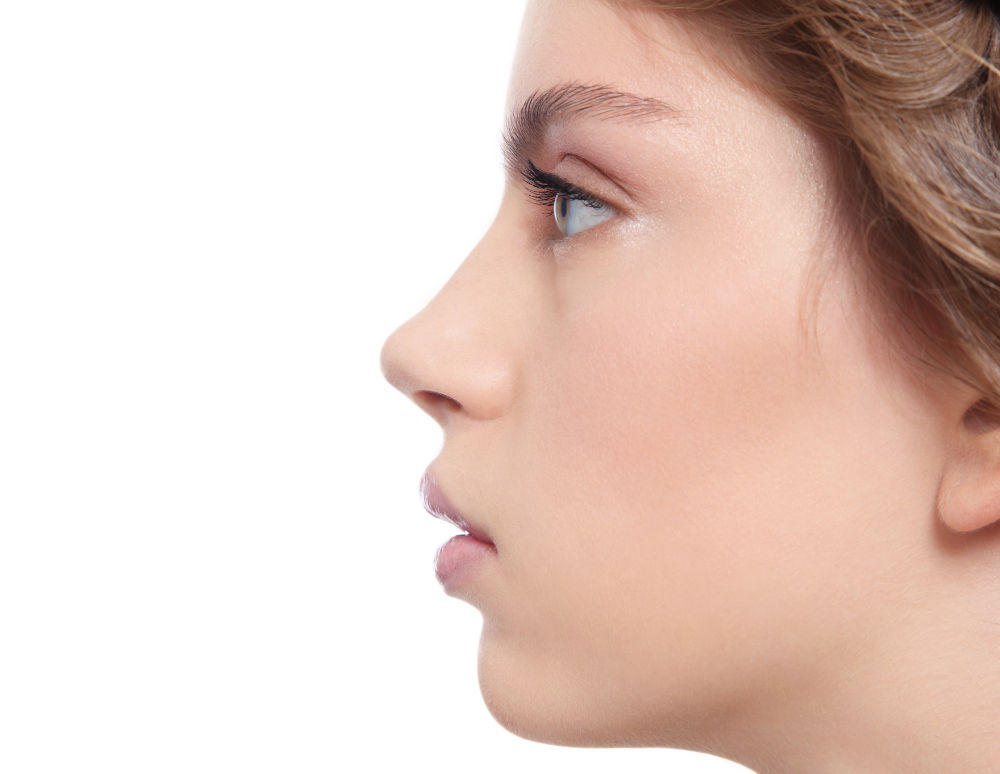 Side profile of a woman with a refined nasal bridge and subtly defined tip that complements overall facial harmony.