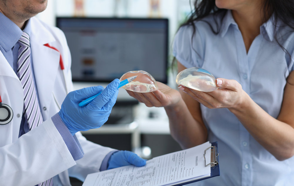 Breast Surgery Consultation – Augmentation and Reduction Costs in Toronto Plastic surgeon explaining breast augmentation and reduction options to a patient