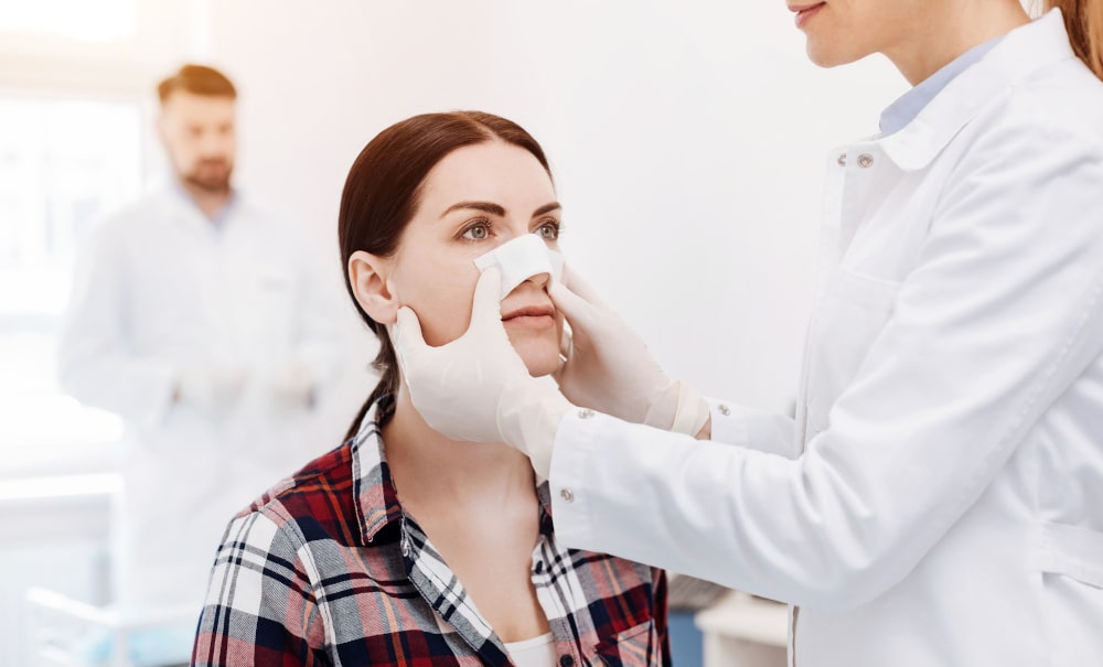 Woman smiling confidently after successful revision nose surgery