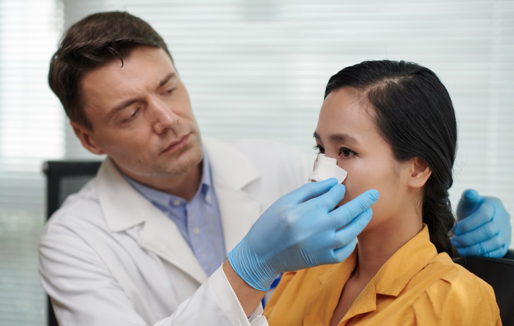 Rhinoplasty for repositioning nasal structures to correct asymmetry, improve breathing, and maintain natural nose shape